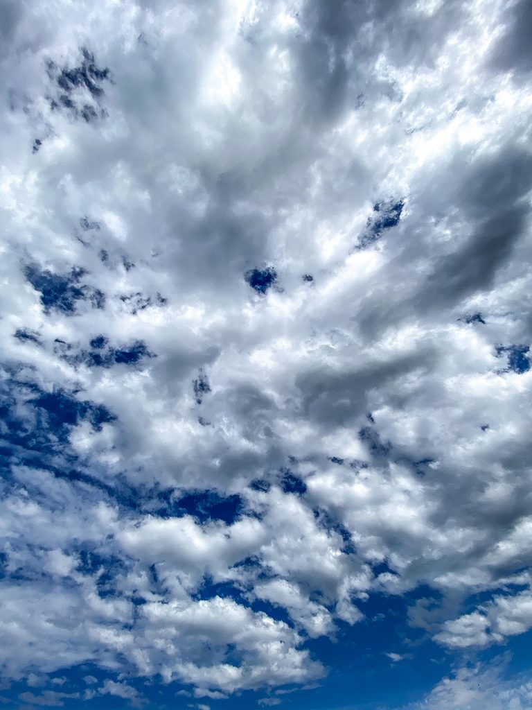 blue skies with white puffy clouds